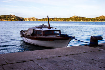 Boat moored on sea against sky