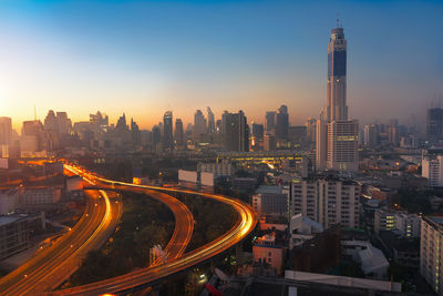 High angle view of illuminated buildings against sky at dusk