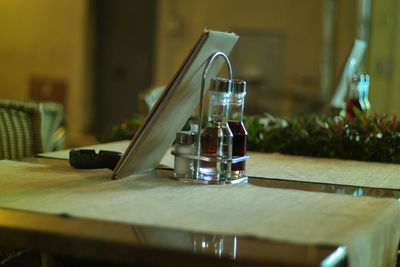 Close-up of glass bottle on table at restaurant