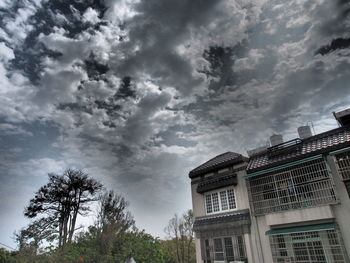 Low angle view of building against cloudy sky