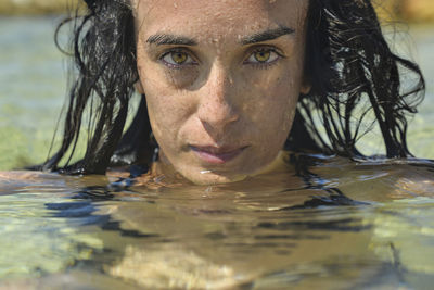 Portrait of young woman swimming in pool