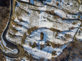 Aerial view of road on snow covered field