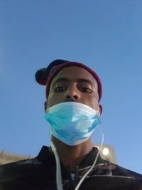 Portrait of mature man against blue sky