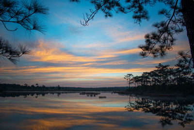 Scenic view of lake against orange sky