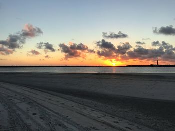 Scenic view of beach against sky during sunset