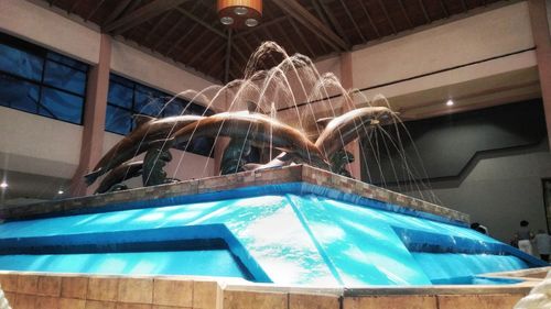 Low angle view of illuminated lighting equipment in swimming pool