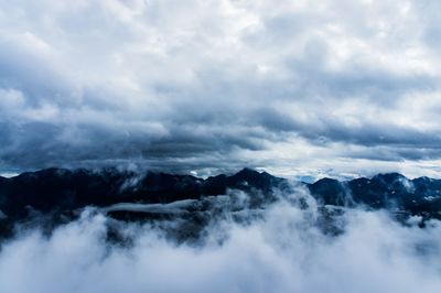 Scenic view of mountains against cloudy sky