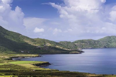 Scenic view of sea and mountains against sky