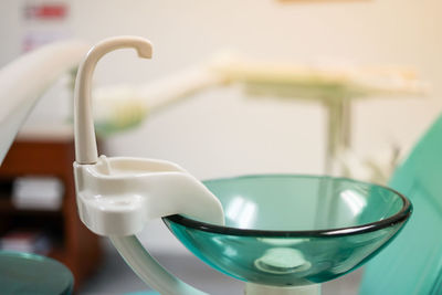 Close-up of drinking glass in bowl on table