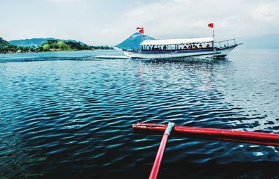 Boat moored on sea against sky