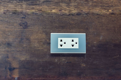 Directly above shot of electrical outlet on wooden table