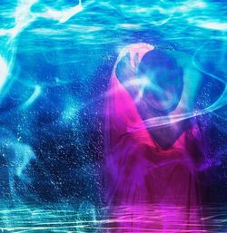 Blurred motion of illuminated lighting equipment in swimming pool