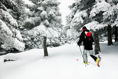 Man skiing on snow covered field