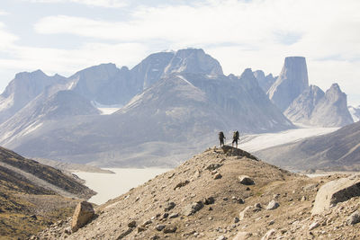 Man on mountain range against sky