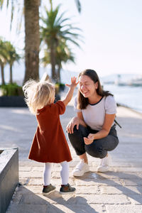 Full length of mother and daughter outdoors