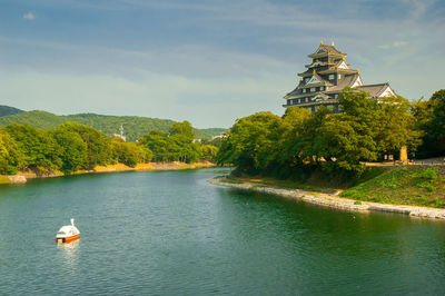 View of sailboat in pond of  okayama jo castle, japan