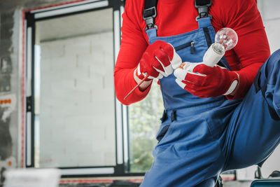 Low section of woman holding hands