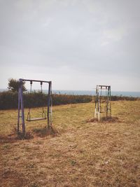 Lifeguard hut on field in park against sky