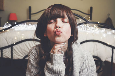 Portrait of beautiful young woman sitting at home