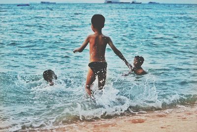 Children playing in swimming pool at beach