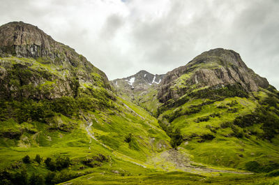 Countryside landscape against mountain range