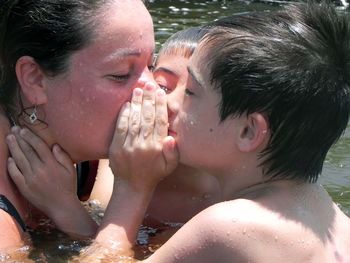 Close-up of shirtless boy with water