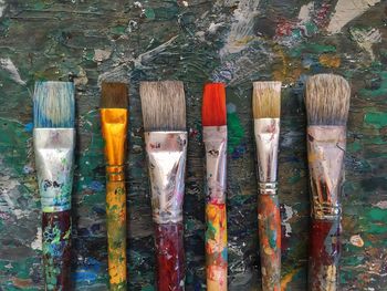 Directly above shot of paintbrushes on table