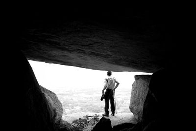 Rear view of man standing on rock