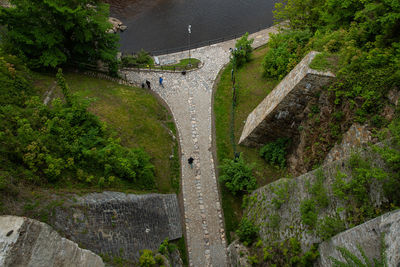 High angle view of bridge over road by trees