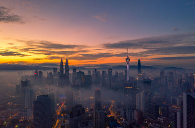 Cityscape against sky during sunset