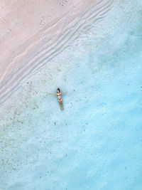Woman swimming in blue sea at beach