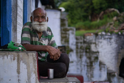 Portrait of senior man sitting outdoors