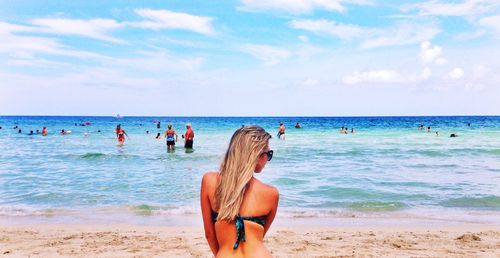 Rear view of young woman at beach