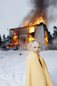 Rescued girl in front of burning house