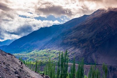 Scenic view of mountains against cloudy sky