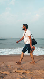 Full length of man on beach against sky