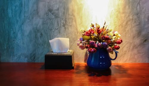 Close-up of flower vase on table at home