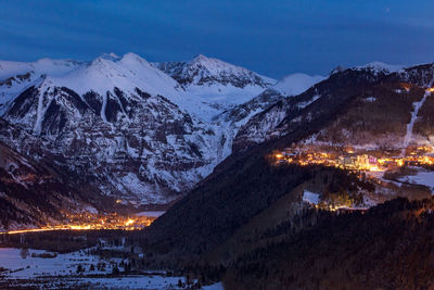 Scenic view of snowcapped mountains against sky at night