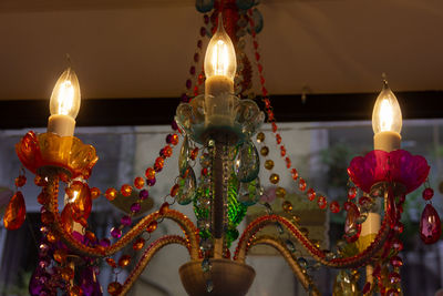 Close-up of illuminated candles in temple