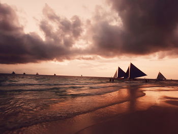 Scenic view of calm sea against cloudy sky