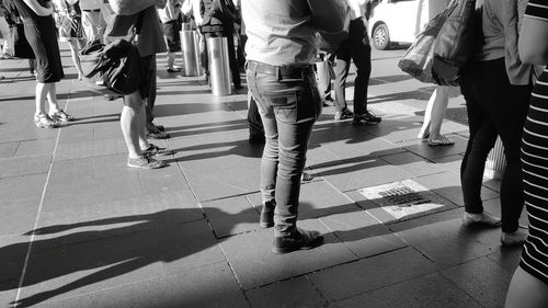 Low section of people walking on zebra crossing