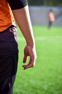 Midsection of man standing on field