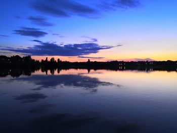 Scenic view of lake against romantic sky at sunset