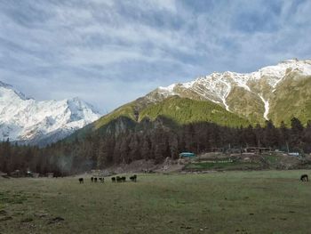 Scenic view of mountains against cloudy sky