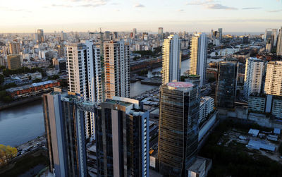 High angle view of modern buildings in city against sky