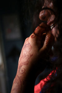 Close-up of woman with henna tattoo