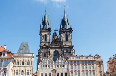 Low angle view of buildings against blue sky