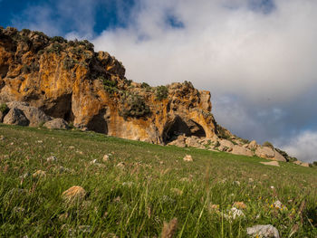 Low angle view of rock formations against sky