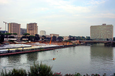 River and buildings against sky