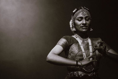 Portrait of woman standing against wall